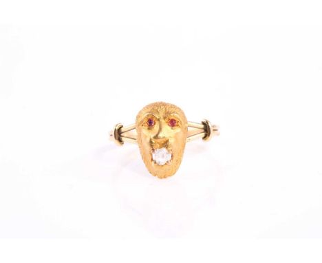 An unusual novelty yellow gold monkey head ring, the animal holding an old cut diamond in its mouth and set with cabochon rub