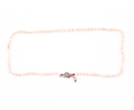 A single strand pearl necklace, light cream off-round and oval pearls graduated from 3.6-5.5mm diameter, knotted strung, with