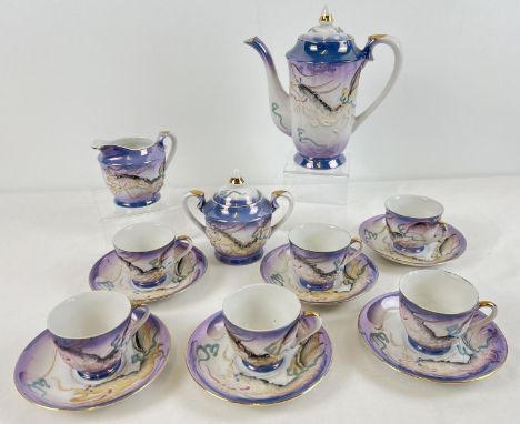 A vintage Japanese ceramic Dragonware 6 setting coffee set with Geisha lithophane bases to cups. With blue &amp; white lustre
