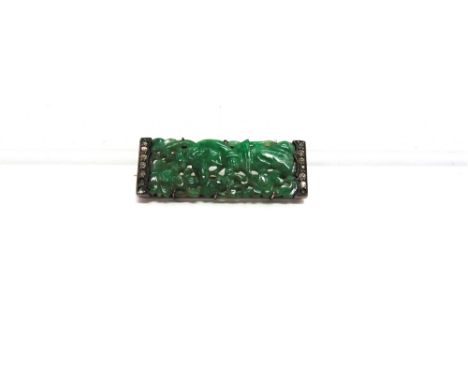 A CARVED AND PIERCED JADE PANEL BROOCH  of rectangular outline, paste set ends, 4.2cm by 1.5cm