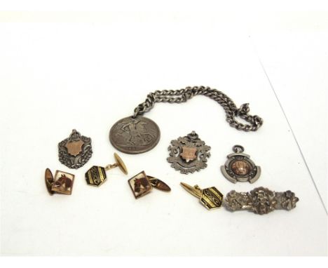 A SILVER WATCH CHAIN  with a drilled 1890 Crown attached; three silver and gold watch fobs; a silver brooch; and two pairs of