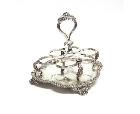 PAUL STORR, A SILVER CRUET WAITER  London 1827, the quatrefoil base with gadrooned rim, shell and leaf quarters, the six bott