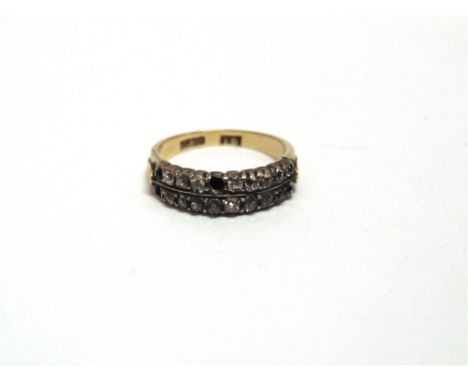 A LATE VICTORIAN DIAMOND RING  of two row design, the small old Swiss cuts collett set, three settings vacant, finger size K,