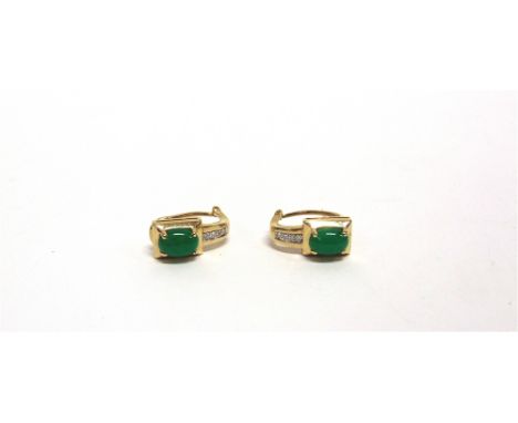 A PAIR OF JADE AND DIAMOND EARRINGS  stamped '750', the oval cabochon with a line of four small diamonds below, the posts fol