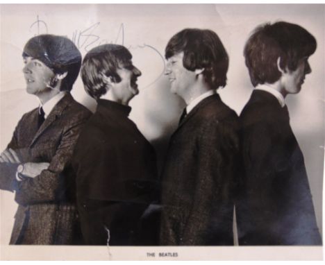 AUTOGRAPHS - THE BEATLES  A black and white group portrait photograph, bearing four signatures, 16.5cm x 21cm.  Note: Greensl