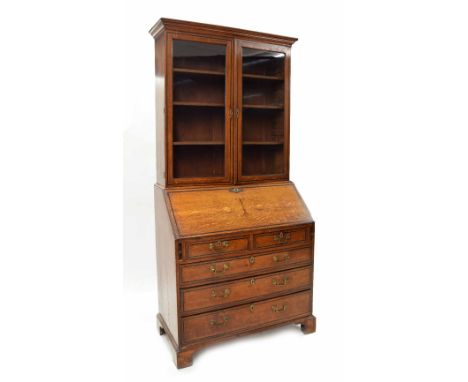 Good Victorian oak bureau bookcase in need of restoration, the moulded stepped pediment over two glazed doors enclosing three