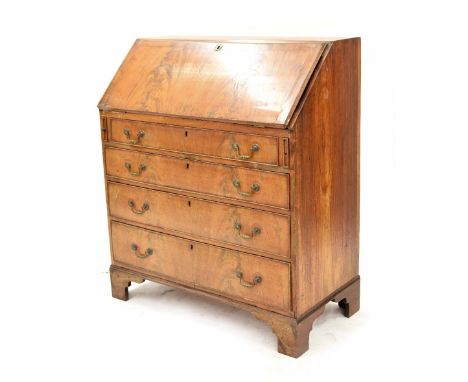 Late 19th century figured walnut veneered bureau, the hinged fall front enclosing a central long drawer flanked by four short