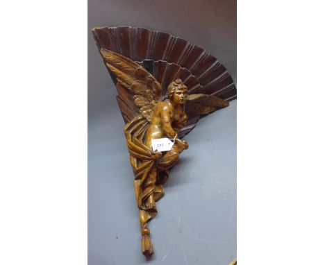 A 19th Century carved olive wood corner wall bracket in the form of an angel. 