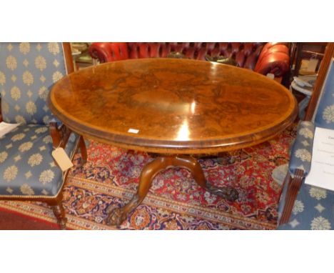 A 19th Century burr walnut loo table, raised on tripod legs and paw feet. Stamped Gillow. H-70cm, W-129cm, D-106cm 