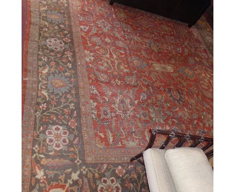A carpet having floral design over red ground with Shah Abbas indigo border. Possibly Mahal. Approx 504cm x 434cm