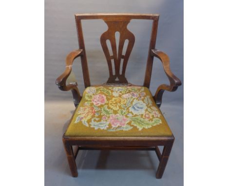 A 19th Century Chippendale style open elbow arm chair with floral tapestry upholstered drop in seat, raised on block legs joi