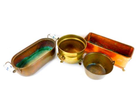 A copper planter, of rectangular form, with brass lion mask ring handles, raised on four brass paw feet, 15cm high, 40cm wide