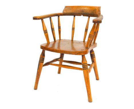 A late 19thC oak and elm captain's bow chair, with a solid seat, raised on ring turned legs united by a double H stretcher, 6