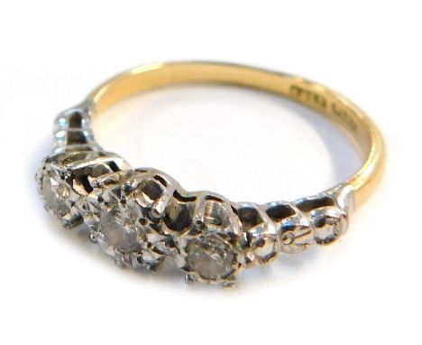 An early 20thC 18ct gold three stone diamond ring, illusion set, with platinum mount, size R 1/2, 2.9g all in.&nbsp;