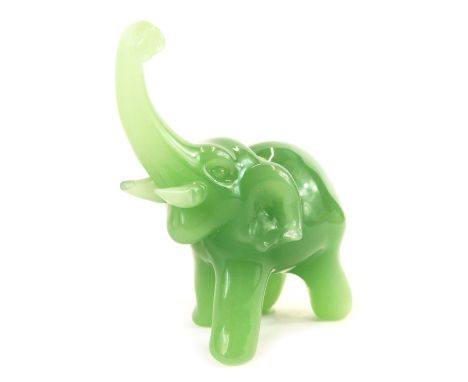 A 20thC jade figure modelled as an elephant, with trunk raised, 8.5cm high. 