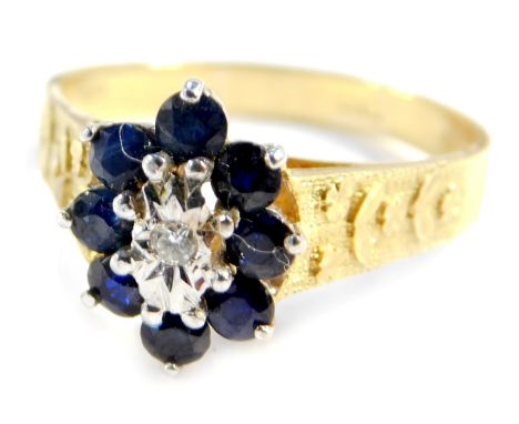 An 18ct gold diamond and sapphire flower head ring, with engraved shoulders, size T, 5g all in.&nbsp;