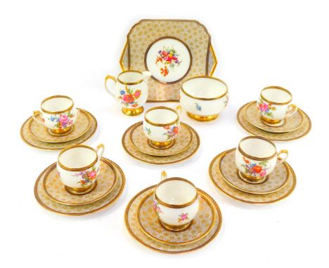 A Shelley porcelain part tea service, each piece decorated with transfer printed flowers against a gilt floral ground, H12611
