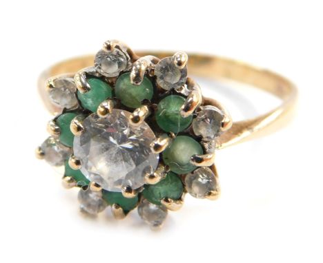 A gold flower head dress ring, set with emerald and CZ stones, formed as layers, hallmarks rubbed, size T, 3.3g all in.&nbsp;