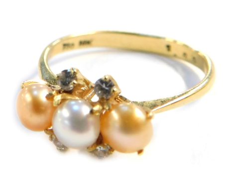 A pearl and diamond dress ring, with three bi-colour pearls, in a yellow metal shank stamped 750 &amp; 18k, size O, 2.7g all 