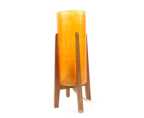 A mid century atomic table lamp, with circular orange plastic cylindrical shade, mounted in a teak stand, 36.5cm high.WARNING