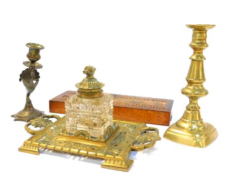 A Victorian brass two handled desk stand, with pierced floral decoration, with a central cut glass ink bottle, with brass mou