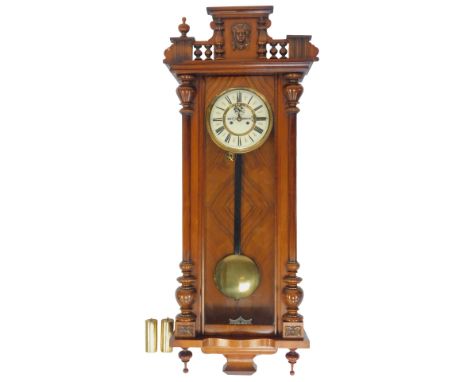 A mahogany cased Vienna regulator wall clock, with cream enamel dial bearing Roman numerals, brass chapter ring, subsidiary s