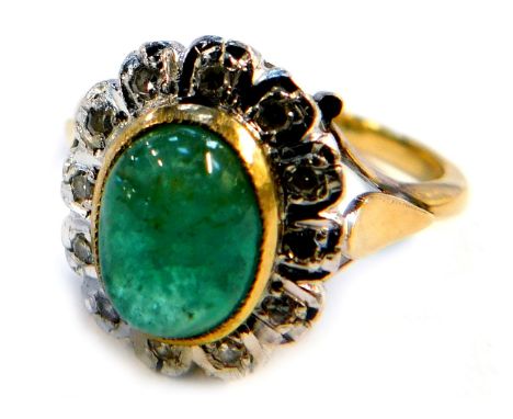 A cabochon emerald and diamond dress ring, on a yellow metal shank stamped 18ct, size P,&nbsp; 5.8g all in.&nbsp;