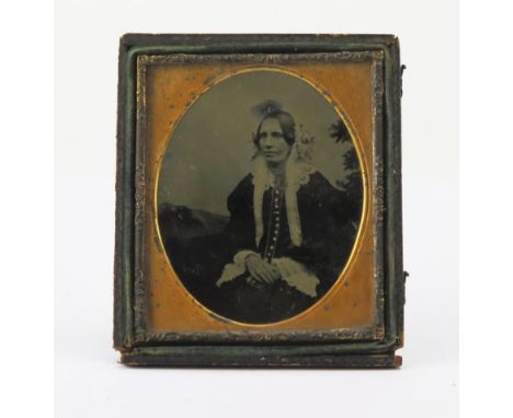A mid 19th century ambrotype half portrait of a seated lady, 8 x 6cm.