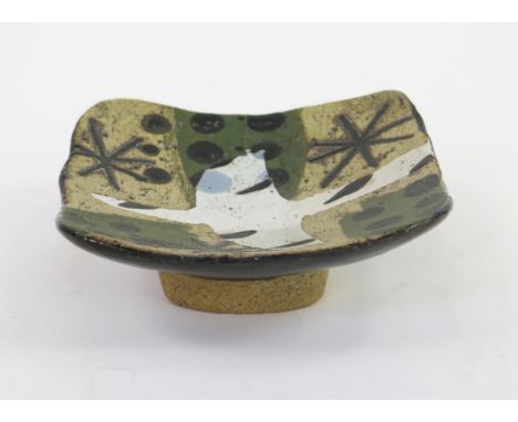 JOHN MALTBY (1936-2020) A small studio pottery dish with abstract stellar, dot and bird design, signed to the base, 12cm wide