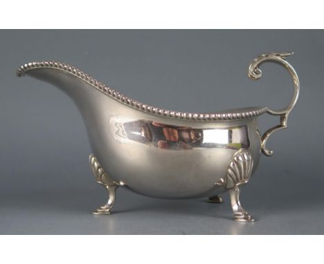 A George V silver sauce boat, maker Harrison Brothers &amp; Howson, Sheffield, 1931, with beaded border, acanthus capped scro