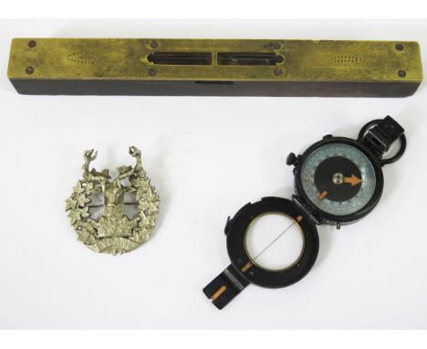 A World War II British hand held compass Mk IX, by J M Glauser, London, a Gordon Highlander's cap badge and a brass mounted s