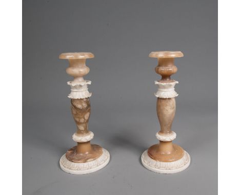 Pair of alabaster candle sticks. Each for one light. Curved round shape with leaf decorations. Sculpted. Probably Volterra fi