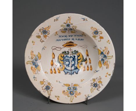 Spanish ceramic dish. Round form with deepened centre. Painted with coat of arms and flowers on white ground. Glaced. 17/18th