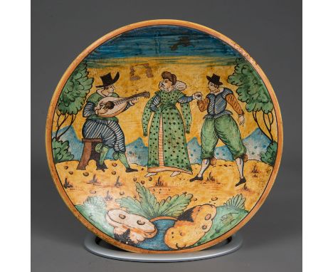 Montelupo ceramic dish. Round form with deepened centre. Painted couple with musicians in multi colours. Glaced. 35 cm diamet