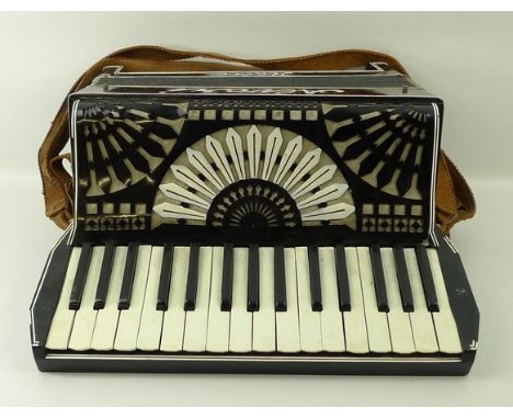 An Alvari black and white piano accordion, cased. 