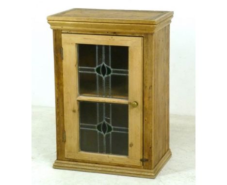 A Victorian pine cabinet, the single door with later added stained glass panels, brass bun handle and single shelf, 64 by 42 