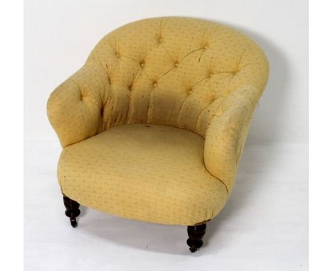 An Edwardian button back tub chair, upholstered in yellow patterned fabric, with turned front legs, 74 by 76 by 67cm high.