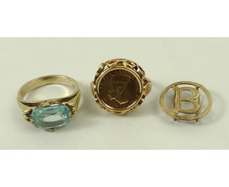 A gold ring set with a 14ct Nefertiti gold coin mounted in a scrollwork setting, size E, 3.1g, a gold ring with a rectangular