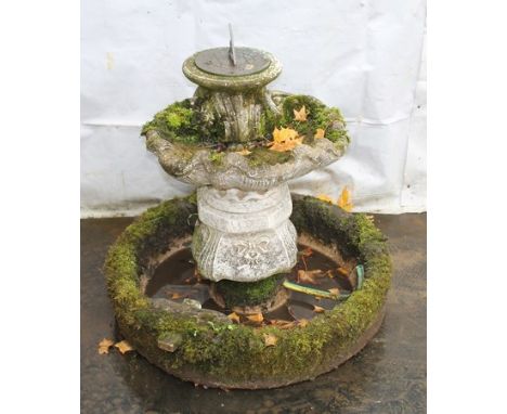 A modern composite stone garden fountain, the top section in the form of scallop shell, bearing sundial, 72 by 64cm high.