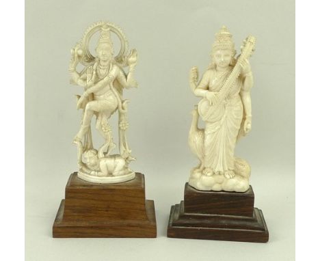 An Indian carved ivory figure of Sarasvati, Goddess of music and learning, late 19th century, playing sitar, peacock below, 1