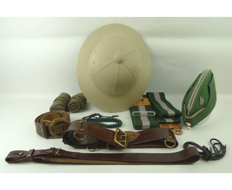 A sun rigid fibre helmet, Sam Browne officer's belt, US cavalry belt and three further belts, a pair of puttees, an Intellige