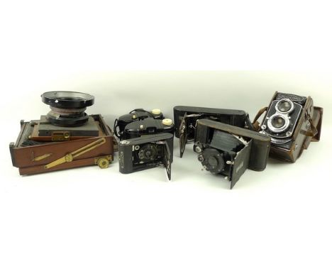 A wooden plate camera with a Kodak Aero-Ektar f:2.5 7in 178mm lens, an Ika camera, Kodak Kodex no 1 camera, Kodak no 0 camera