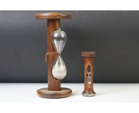Early 20th century wooden sand timer (23.5cm high), together with a further 20th century sand timer (12.5cm high) 