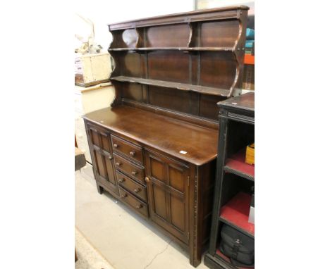 Ercol Dark Elm Dresser with two plate shelves to back over a base with four drawers and two cupboard doors, 145cm long x 50cm