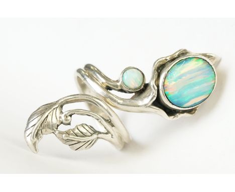 A silver art nouveau style dress ring set with opal cabachons 