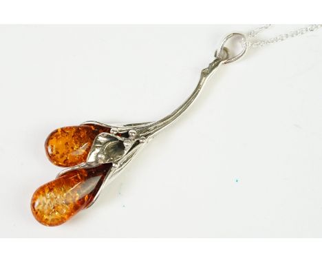 A silver and amber pendant necklace on silver chain 