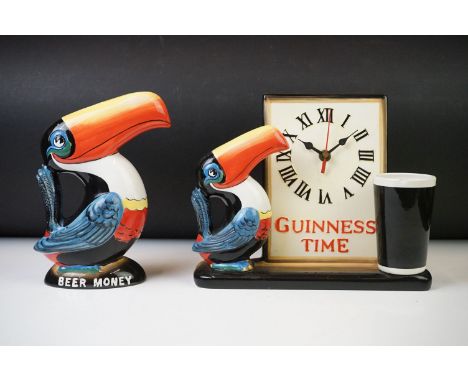 A Guinness advertising clock, 'Guinness Time', modelled with toucan, clock and a pint of Guinness, 'G0051', 21cm high and a G