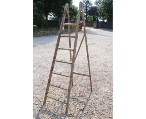 A pair of mid twentieth century wooden step ladders. 