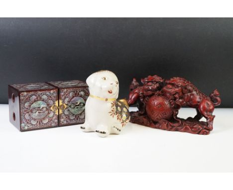 A large Chinese red resin ornamental foo dog together with a ceramic Thai Benjarung dog and a Chinese black lacquered trinket