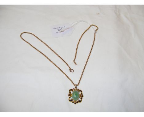 A jade pendant in gold mount with chain 
